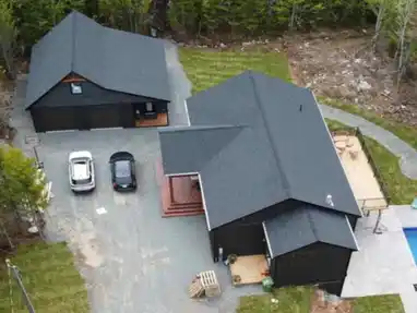 Aerial view of asphalt shingle roofs on home and detached garage in East Uniacke, Nova Scotia